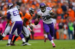 Running back Adrian Peterson #28 of the Minnesota Vikings rushes for a 48-yard touchdown against the Denver Broncos.