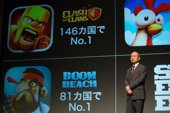 SoftBank Corp. chairman and CEO Masayoshi Son speaks in front of mobile game images of Clash of Clans and Boom Beach by gamemaker Supercell in Tokyo, Japan.
