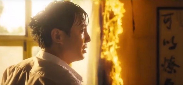 Shen Teng stands near a burning portion of a classroom in one scene from "Goodbye Mr. Loser," one of the unexpected successful comedies of 2015.