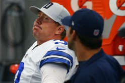 Dallas Cowboys quarterback Brandon Weeden (L) talks with injured Tony Romo on the bench.