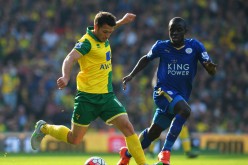 Wes Hoolahan of Norwich City and Ngolo Kante of Leicester City compete for the ball.