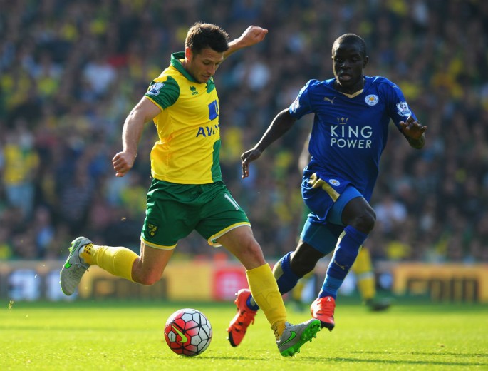 Wes Hoolahan of Norwich City and Ngolo Kante of Leicester City compete for the ball.