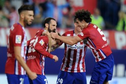 Luciano Vietto of Club Atletico de Madrid celebrates with Tiago Mendes after scoring Atletico's opening goal during their derby with Real Madrid.