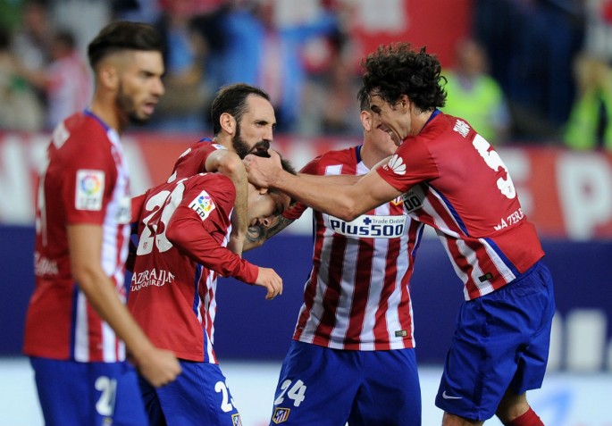 Luciano Vietto of Club Atletico de Madrid celebrates with Tiago Mendes after scoring Atletico's opening goal during their derby with Real Madrid.