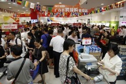 Shoppers buy products at a Guangzhou Grandbuy store, the largest department-store chain in the city.