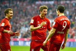 Bayern Munich's Thomas Müller (middle) celebrates with teammates Mario Götze and Robert Lewandowski.