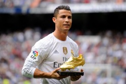 Real Madrid's Cristiano Ronaldo receives his European Golden Shoe award during their weekend match against Levante for topscoring European league matches last season.