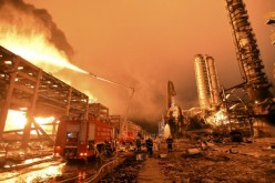 Firefighters try to extinguish a fire in Zhangzhou, Fujian Province, after an explosion hit part of an oil storage facility owned by Dragon Aromatics, in this April 7, 2015 photo.