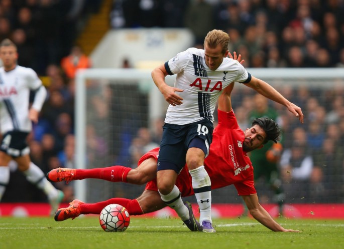 Tottenham striker Harry Kane is tackled by Liverpool midfielder Emre Can.
