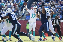 Miami Dolphins quarterback Ryan Tannehill (#17) throws a pass under pressure against the Tennessee Titans.