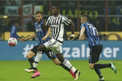 Juventus midfielder Paul Pogba (middle) competes for the ball with Inter Milan's Davide Santon (L) and Marcelo Brozovic.