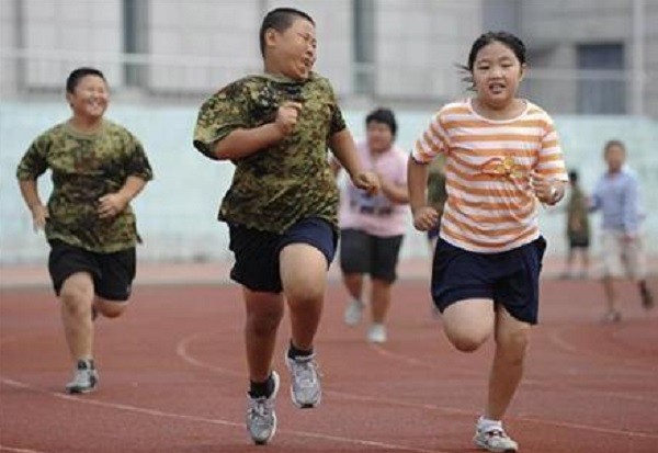 Children exercise during a weight-loss summer camp in China.