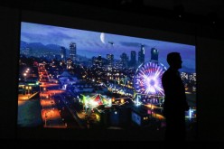 Andrew House, president and chief executive officer of Sony Computer Entertainment Inc., is silhouetted as he watches a trailer for the Grand Theft Auto Five (GTA 5) video game for PlayStation 4 (PS4) during the Sony Corp. media event ahead of the E3 Elec