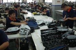 Workers make the final check on products made by a factory in Dongguan, China's manufacturing hub.