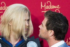 Chris Hemsworth takes a close look at a figure of himself in character as Thor at the premiere of Marvel's 'Avengers: Age Of Ultron' at the Dolby Theatre in Los Angeles, California.