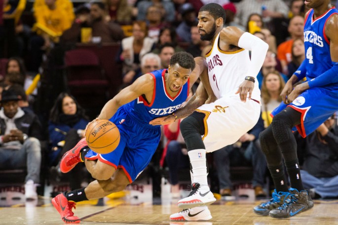 Sixers point guard Ish Smith drives around Cavs' Kyrie Irving.
