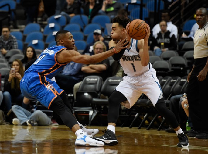 Minnesota Timberwolves rookie point guard Tyus Jones (R) goes against Oklahome City Thunder's Russell Westbrook.
