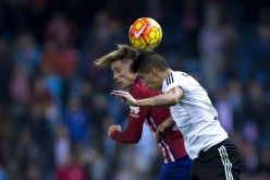 Valencia defender João Cancelo competes for the ball against Atletico Madrid forward Fernando Torres.