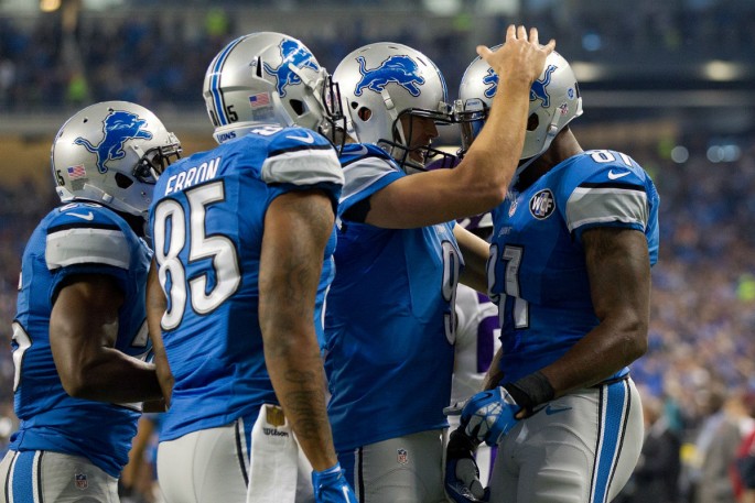 Detroit Lions wide receiver Calvin Johnson (#81) celebrates with teammates after scoring a touchdown against the Minnesota Vikings.