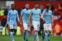 Manchester City players walk off the pitch after a draw with Manchester United.