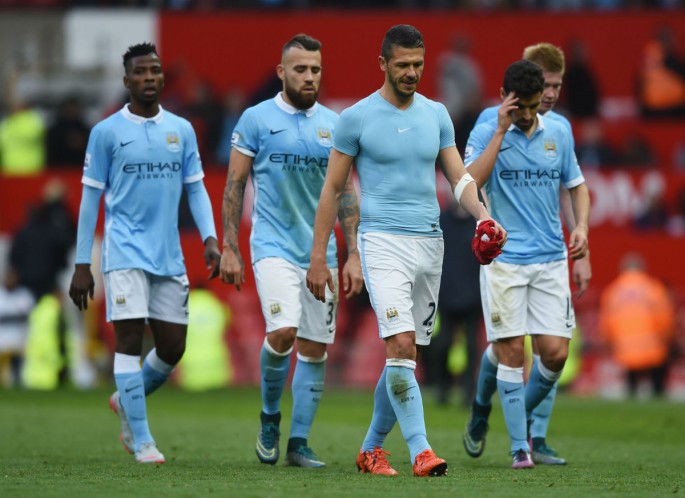 Manchester City players walk off the pitch after a draw with Manchester United.
