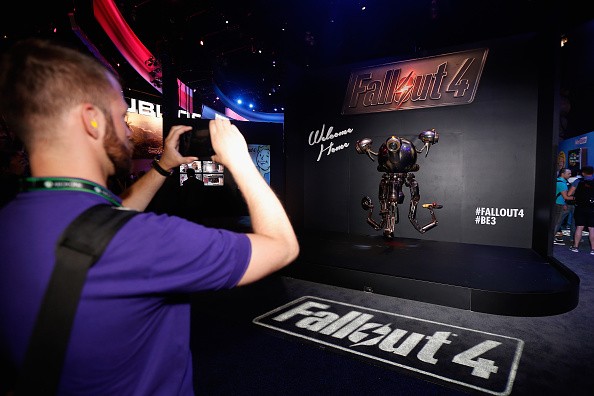A game enthusiast takes a photograph of a 'Mr. Handy' robot in promotion to 'Fallout 4' at the Annual Gaming Industry Conference E3 at the Los Angeles Convention Center on June 16, 2015 in Los Angeles, California. 