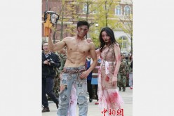 Two teachers dress up and attend the Halloween parade held in Sichuan Southwest Vocational College of Civil Aviation in Chengdu, capital of southwest China's Sichuan Province on October 31, 2015. 