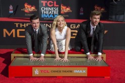 Actors Josh Hutcherson, Jennifer Lawrence and Liam Hemsworth pose at the Stars From Lionsgate's 