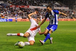 Deportivo La Coruna winger Lucas competes for the ball against Rayo Vallecano's Antonio Amaya.