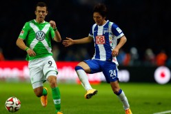 Hertha Berlin winger Genki Haraguchi competes for the ball against Wolfsburg's Ivan Perisic.
