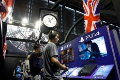 Gamers play the video game 'Assassin's Creed Syndicate' developed by Ubisoft on PlayStation games consoles PS4 at Paris Games Week, a trade fair for video games on October 29, 2015 in Paris, France. 