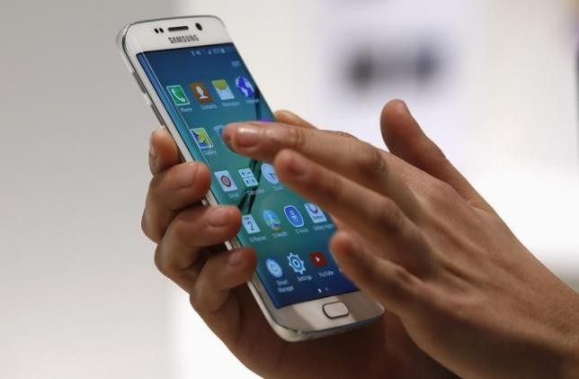 A hostess displays Samsung Galaxy S6 Edge smartphone during the Mobile World Congress.