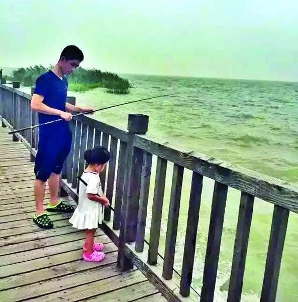 Zhu with daughter Grace trying their luck to catch some fish together.