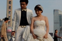 A newlywed couple walk down the stairs after posing for pictures at the Bund in central Shanghai.