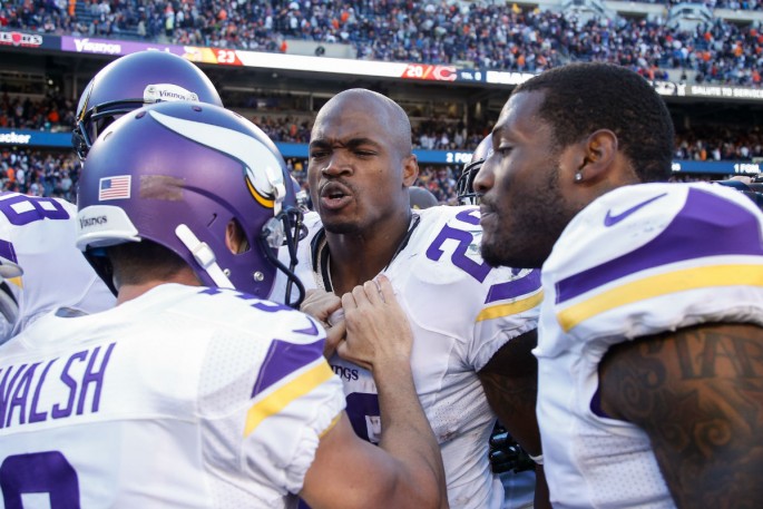 Minnesota Vikings kicker Blair Walsh (#3) celebrates the winning field goal versus the Chicago Bears with Adrian Peterson and his teammates.