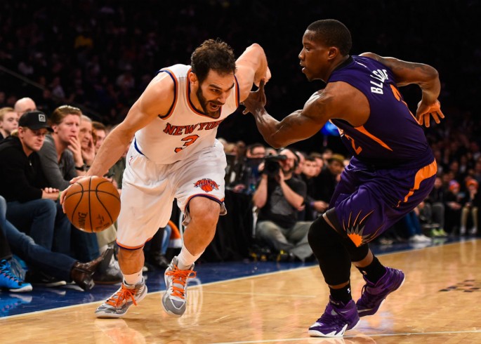 New York Knicks' Jose Calderon (L) drives past Phoenix Suns' Eric Bledsoe.