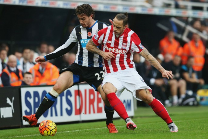 Stoke City winger Marko Arnautović (R) competes for the ball against Newcastle United's Daryl Janmaat.