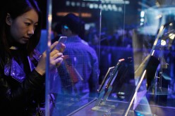 A woman takes a photo of a Vertu phone at the product's launch in Shanghai last year.