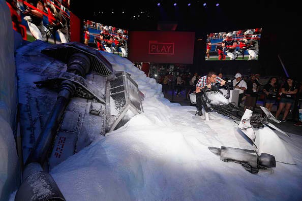 A game enthusiast poses for a photo on a speeder in promotion to 'Star Wars Battlefront' during the Annual Gaming Industry Conference E3 at the Los Angeles Convention Center on June 16, 2015.