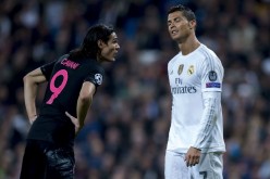 Real Madrid's Cristiano Ronaldo (R) talks with PSG's Edinson Cavani during their recent Champions League match.