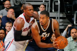 Utah Jazz power forward Derrick Favors posts up against Atlanta Hawks' Paul Millsap.