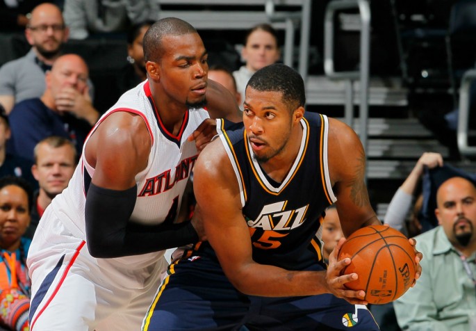 Utah Jazz power forward Derrick Favors posts up against Atlanta Hawks' Paul Millsap.