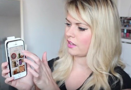 A woman checks out some of the best health & fitness apps on her mobile phone.
