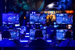 Visitors try out the massively multiplayer online role-playing game 'World Of Warcraft' at the Blizzard Entertainment stand at the Gamescom 2015 