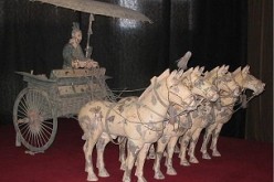 A bronze chariot owned by the First Emperor of China on display in a museum.