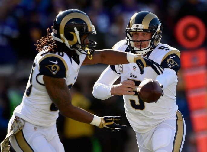 St. Louis Rams quarterback Nick Foles (R) hands off the football to running back Todd Gurley.