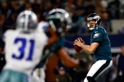 Philadelphia Eagles quarterback Sam Bradford (R) prepares to throw the football against the Dallas Cowboys.