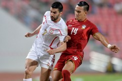 Lebanon striker Hassan Maatouk competes for the ball against Thailand's Teeratep Winotha.