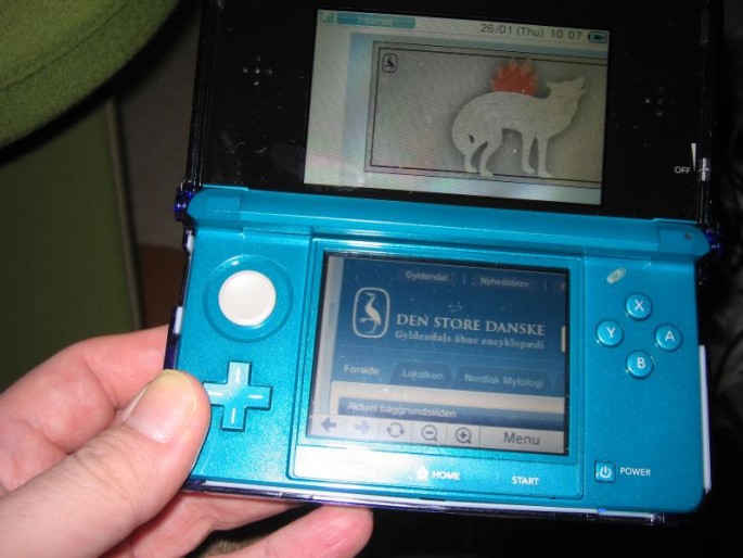 Nintendo 3DS handheld video game console with gamer playing "Den Store Danske."