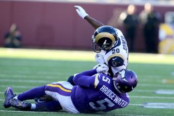 Minnesota Vikings quarterback Teddy Bridgewater (#5) was knocked down by St. Louis Rams' Lamarcus Joyner (#20).